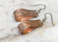 We are still taking Christmas orders until December 10th. Order early so your items arrive on time. 1.5 inch copper hoop earrings that dangle from surgical steel ear hooks. These earrings feature a tooled leather design that has been embossed on solid copper. Perfect for every day and those summer and fall nights out. These are light enough to wear all day but you will know they are there. The earrings are 8mm wide and dangle from the hooks at almost 2 inches long. Wear with jeans and a tshirt o Etched Copper Jewelry, Hammered Copper Earrings, Unique Hoop Earrings, Raw Stone Earring, Crescent Earrings, Contemporary Earrings, Artisan Earrings, Large Hoop Earrings, Leather Texture