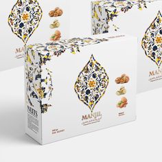 three boxes of marzili almonds on a white surface with an intricate design