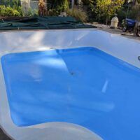 an above ground swimming pool with blue water