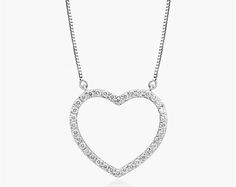 14K White Gold Lab-Created Diamond Open Heart Pendant Necklace. Slim and sparkling, make a simple statement of love with this classic lab-created diamond heart pendant. Crafted in 14K gold, this petite style features lab-created round brilliant-cut diamonds along the facing edge. This pendant is attached to a box chain and that secures with a spring-ring clasp. The necklace measures 18inches with an extra jump ring at 16 inches for versatility. Classic Cubic Zirconia Heart Necklace For Valentine's Day, Classic Valentine's Day Heart Necklace In Cubic Zirconia, Classic Heart Pendant Necklace In Cubic Zirconia, Classic Open Heart Diamond Necklace For Gift, Classic Open Heart Necklace With Brilliant Cut, Classic Necklace With Brilliant Cut Open Heart, Classic Heart Necklace With Cubic Zirconia And Diamond Accents, Classic Heart Necklace With Diamond Accents In Cubic Zirconia, Classic Heart Necklace With Diamond Accents And Cubic Zirconia