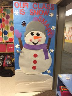 a classroom door decorated with a snowman and the words our class is snow smart