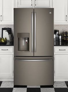 a stainless steel refrigerator with ice and water dispenser on the door in a white kitchen