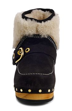 Fuzzy shearling trim updates the cozy-chic vibes of this clog-inspired boot while polished studs accentuate the wood-grain sole. 1 1/2" heel 5" shaft Pull-on style Cushioned footbed Leather and genuine shearling (India) upper and lining/rubber sole Imported Clog Boots, Chic Vibes, Cozy Chic, Kids Sneakers, Black Suede, Bootie, Wood Grain, Black Boots, Designer Shoes