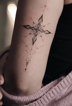 a woman with a star tattoo on her arm