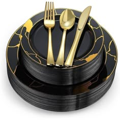 a black and gold plate topped with forks and spoons