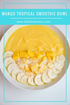 mango tropical smoothie bowl with banana slices and powdered sugar on top, in a white bowl