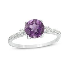 A colorful way to show your love, this gemstone and diamond engagement ring is the start of something beautiful. Crafted in cool 10K white gold, this adventurous style features a 7.0mm bright purple amethyst flanked by a pair of sparkling diamonds. Dainty diamonds line the shank for the perfect touch of shimmer. Radiant with 1/8 ct. t.w. of diamonds and a brilliant buffed luster, this engagement ring is a unique choice to celebrate your romance. Purple Diamond Ring With Diamond Accents For Anniversary, Purple Diamond Ring With Accents For Anniversary, Fine Jewelry Purple Rings With Diamond Accents, Purple Diamond Birthstone Ring With Round Cut, Amethyst Diamond Birthstone Ring With Round Cut, Amethyst Round Cut Diamond Ring Birthstone, Amethyst Diamond Ring With Round Cut, Amethyst Round Cut Diamond Birthstone Ring, Purple Birthstone Ring With Prong Setting