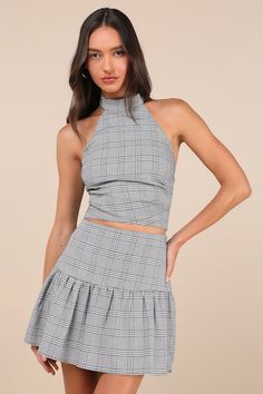 Compose a look that's sure to get you endless compliments with the Lulus Trendy Momentum Black and White Plaid Mini Skirt! Lightweight woven fabric boasts a plaid, houndstooth-style pattern as it shapes this cute skirt that has a high waist and a ruffled, lightly flaring panel that falls to a mini hem. Hidden zipper/clasp at side. Pair with the matching top for a complete look! Fit: This garment fits true to size. Length: Mid-thigh. Size medium measures 16.5" from waist to hem. Waist: Fitted - v Fitted Plaid Mini Skirt For Spring, Spring Fitted Plaid Skort, Fitted Plaid Mini Skort, Fitted Gingham Mini Skirt, Fitted Plaid Tiered Skirt, Chic Fitted Plaid Skirt, Spring Fitted Houndstooth Skirt, Fitted Plaid Skirt For Party, Chic Fitted Houndstooth Skirt