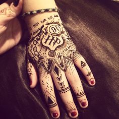 a woman's hand with tattoos on it