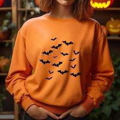 🦇 Vintage Bats Sweatshirt | Halloween Bats 🎃 | Vintage Halloween Sweater 👻 | Spooky Season 🦇 | Bat Gift Sweatshirt Description: 🎃 Get Spooky in Style! 🎃 Celebrate the spooky season with our Vintage Bats Sweatshirt--a perfect blend of eerie charm and cozy comfort. Featuring a timeless bat design 🦇, this sweatshirt captures the essence of vintage Halloween, making it a must-have for anyone who loves to celebrate in style. Features: 🦇 Vintage-Inspired Design: Show off your Halloween spirit Spooky Orange Long Sleeve Tops, Fall Costume Party Long Sleeve Tops, Orange Long Sleeve Spooky Top, Long Sleeve Tops For Costume Party, Fall, Long Sleeve Tops For Costume Party In Fall, Spooky Orange Crew Neck Top, Spooky Long Sleeve Halloween Tops, Orange Crew Neck Halloween Sweatshirt, Orange Long Sleeve Halloween Sweater