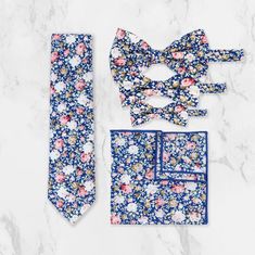 Elevate your fashion game with our trendsetting collection of floral ties, pocket squares, and bow ties, expertly handcrafted from luxuriously soft, 100% high-quality cotton. Great for the guy who loves to pull off bold, standout styles, these floral accessories are essential for any well-dressed wardrobe. Perfect for weddings, formal events, or even adding a stylish touch to everyday outfits, our versatile floral designs suit every occasion. Whether you're preparing for a day at the races, sele Elegant Blue Sets With Floral Print, Elegant Blue Floral Print Sets, Elegant Blue Set With Floral Print, Elegant Summer Suit And Tie Accessories For Groom, Elegant Suit And Tie Accessories For Groom In Summer, Elegant Summer Groom Sets, Blue Business Sets For Spring, Summer Floral Print Ties, Summer Wedding Ties For Groom