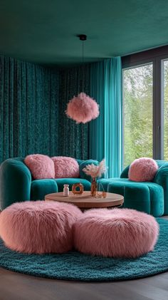 a living room filled with blue couches and pink rugs