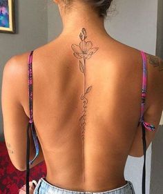 a woman with a flower tattoo on her back