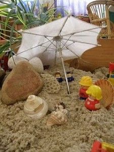 an umbrella and some toys in the sand