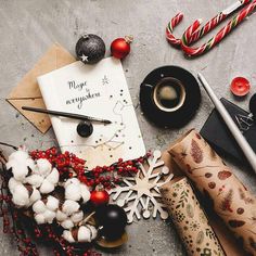 a table topped with wrapping paper and christmas decorations