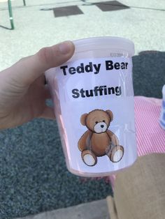 a person holding a cup with a teddy bear on it