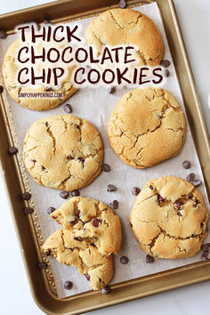 chocolate chip cookies sitting on top of a cookie sheet