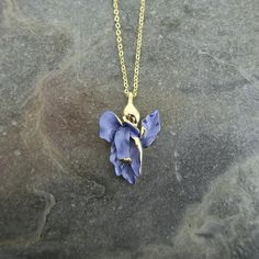 Our Iris flower necklace adds elegance to any outfit and make a fabulous Valentines gift for a flower lover. Each necklace is hand finished in blue enamel. This beautiful necklace embodies nature with its intricate realistic design and attention to detail. Designed by us, in our London office. The Iris is a symbol of hope, wisdom, trust and valor. Irises make fabulous gifts for nature lovers, they are the birth flower for the month of February, the gift to give for a 25th wedding anniversary and perfect for any occasion.  Size: (W) 21mm x (L) 32mm x (drop) 48.5cm Metal colour: gold Necklace clasp: lobster Chain length: 41cm chain with 7.5cm extension chain Each item is presented on a recycled paper gift card (as shown), packed in a biodegradable bag and then placed in an eco-friendly envel