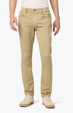 Always trendy, these slim-cut pants are made from a softened cotton blend and garment-dyed in a solid hue for versatility. 29" inseam; 11" rise (size 32) Zip fly with button closure Five-pocket style 99% cotton, 1% elastane Machine wash, tumble dry Imported Model stats: 6'1" height, 32" waist. Model is wearing size 32. Solid Chinos With Five Pockets And Tapered Leg, Solid Color Straight Fit Cotton Bottoms, Slim Fit Cotton Pants With Five Pockets, Cotton Chinos With Five Pockets For Spring, Mid-rise Solid Cotton Pants, Cotton Jeans Trousers, Spring Cotton Chinos With Five Pockets, Solid Mid-rise Cotton Pants, Straight Cotton Bottoms For Spring