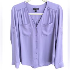 New Without Tags Express Lilac-Lavender Color Shirt. Semi Sheer Button Down Whit From Chest Pockets In Front. Sleeve Long And 3/4 Rolled Up. Lightweight V- Neck Pit To Pit:19 1/2” Shoulder To Bottom:25” Sleeve Leght Unrolled:24” Sleeve Leght Rolled:13” 100% Polyester Excellent Condition Lavender Long Sleeve Shirt For Work, Spring V-neck Purple Shirt, Long Sleeve Lavender Shirt For Spring, Lavender Long Sleeve Shirt For Spring, Purple Button-up Blouse For Work, Purple V-neck Blouse With Buttons, Classic Purple Blouse With Button Closure, Purple Button-up Workwear Tops, Casual Purple Office Blouse