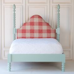 a bed with a checkered upholstered headboard and foot board is shown