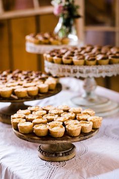 there are many small pies that are on the cake plate and on the table