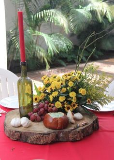 a table topped with a wine bottle and flowers