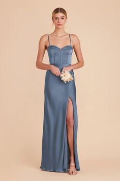 a bridesmaid in a blue dress with a slited skirt and spaghetti straps