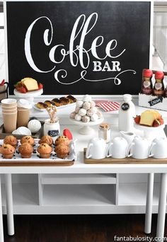 a coffee bar with cakes, muffins and cupcakes on the table