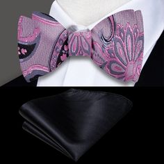 Elevate Your Style: Light Pink and Black Paisley Silk Bow Tie Indulge in sophistication with our exquisite light pink and black paisley silk bow tie. This distinctive accessory is a testament to timeless elegance and versatility, designed to complement your attire with a touch of refinement and flair. The Elegance of Paisley: A Timeless Statement Bow Tie & Pocket Square Set: Whether purchased individually or as a matching set with a pocket square, this ensemble offers a cohesive and refined look Elegant Purple Party Ties, Elegant Pink Standard Tie And Accessories, Elegant Pink Standard Tie Suit Accessories, Elegant Pink Standard Tie, Elegant Pink Ties For Black Tie Occasions, Fitted Pink Suit And Tie Accessories For Formal Occasions, Elegant Fitted Bow For Gift, Elegant Fitted Bow As Gift, Fitted Butterfly Knot Bow Tie For Black-tie Events