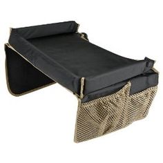 a black and gold baby changing table with mesh inserts on the sides, attached to an ironing board