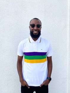 Celebrate Mardi Gras with this stylish white short sleeved Mardi Gras shirt. This shirt features purple, green and gold solid stripes across the chest. Small lines of purple, green and gold are around the collar. White Summer Shirt With Striped Collar, Green Short Sleeve T-shirt With Three Stripes, Fitted Short Sleeve Polo Shirt With Striped Collar, Fitted White Tops With Striped Collar, White Polo Shirt With Striped Collar For Spring, Spring White Polo Shirt With Striped Collar, Casual Multicolor Polo Shirt With Striped Collar, Multicolor Short Sleeve Tops With Striped Collar, Multicolor Short Sleeve Top With Striped Collar