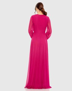 a woman in a long pink dress is looking back at the camera and she has her hands on her hips