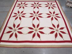 a red and white quilt is laying on the floor