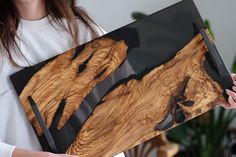 a woman holding a piece of wood that looks like it has been cut into pieces