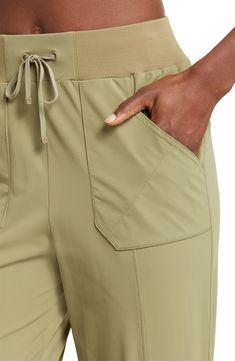 A ribbed elastic waistband and an adjustable drawstring bring easy-wear comfort to lightweight, stretchy joggers finished with convenient pockets. 28 1/2" inseam; 4 1/2" leg opening; 12" front rise; 16" back rise 77% nylon, 23% spandex with 95% nylon, 5% spandex and 87% polyester, 13% spandex contrast Machine wash, line dry Imported Spring Utility Joggers With Elastic Waistband, Utility Style Relaxed Fit Joggers With Drawstring, Relaxed Fit Utility Joggers With Drawstring, Everyday Sporty Cargo Pants With Elastic Waistband, Sporty Everyday Cargo Pants With Elastic Waistband, Athleisure Cargo Pants For Everyday, Stretch Cargo Pants With Elastic Waistband For Everyday, Athleisure Cargo Pants With Elastic Waistband And Relaxed Fit, Athleisure Solid Cargo Pants With Elastic Waistband