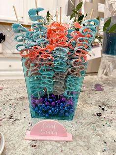 a vase filled with lots of different colored beads