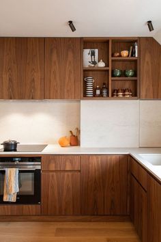 a kitchen with wooden cabinets and white counter tops