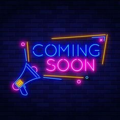 a neon sign that says coming soon with a megaphone in the center and a brick wall behind it