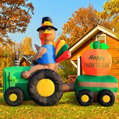 a large inflatable thanksgiving decoration sitting on top of a tractor