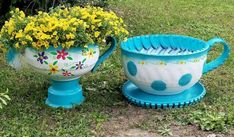 two flower pots sitting on top of each other in the grass