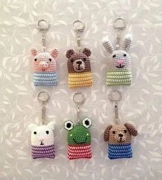 four key chains with small stuffed animals on them