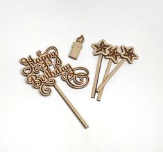 three wooden cake toppers with the words happy birthday written on them and star decorations