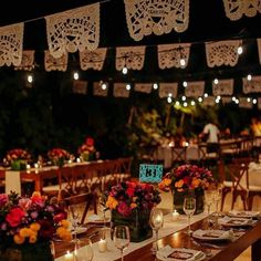 the tables are set with place settings for dinner guests to eat and have candles lit in front of them