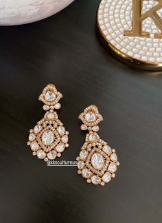 "A jewel in itself, statement gold plated gold finish stud earrings studded with Moissanite Polki in bezel. Light in weight.. Perfect party wear on any Indian / Indo Western Attire. Premium Quality as always.  👉🏻Size: 2\" length 👉🏻Gold plated on Brass as base metal. 👉🏻Earrings Closure - Push Back & clip back. We want you to LOVE your new jewelry!  CARE TIP  1. Keep away from moisture and perfume 2. Store in cotton or zip lock bags or air tight boxes.  3. Spot cleaning only.  4. Jewelry is the last thing you should wear and the first thing you should remove.  Send us an email if you need help!  SHIPPING & TURNAROUND  We follow item dispatch in 1-2 business days for most of our shipments. All pre orders will take approximately 3 weeks. We offer Free domestic delivery across US. Most de Kundan Studs, Jewelry Kundan, Cocktail Jewelry, Back Jewelry, Wedding Jewelry Earrings, Indo Western, Diamond Stud Earrings, Western Jewelry, Diamond Gold