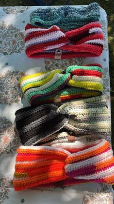 several knitted headbands laid out on a table