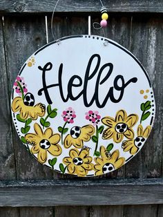 a sign that says hello with flowers on it