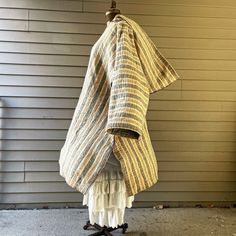 a coat hanging on a clothes rack in front of a house