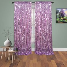 purple sequin curtains hanging on the side of a window in a room with hardwood floors