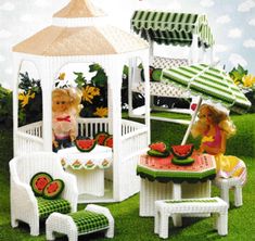 a doll house with furniture and accessories in the grass